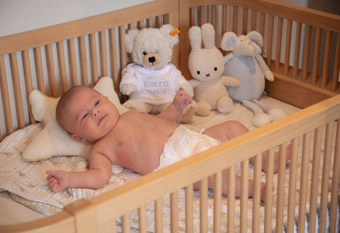 Baby in cot looking at the camera