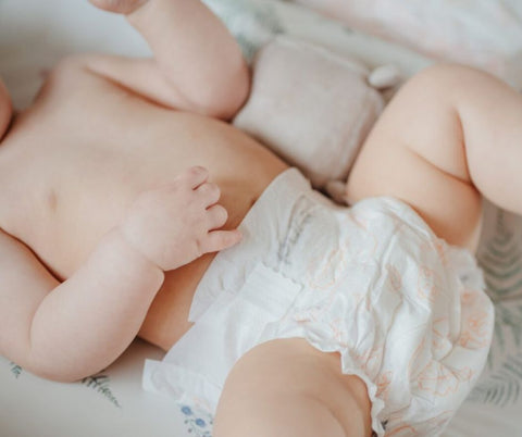 Baby lying on changing matt in a Pura eco nappy