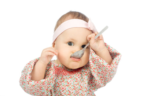 Baby with spoon in mouth