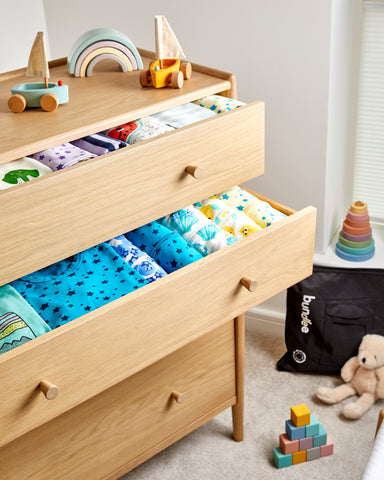 Tidy drawers with baby clothes in
