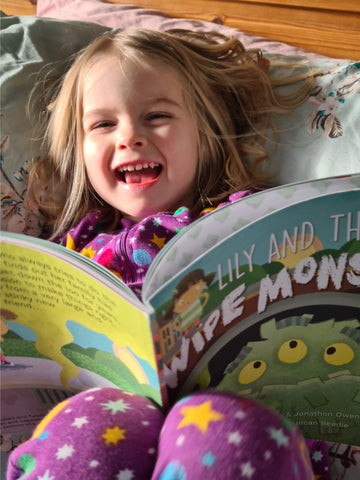 Girl reading Lily and The Wipe Monster