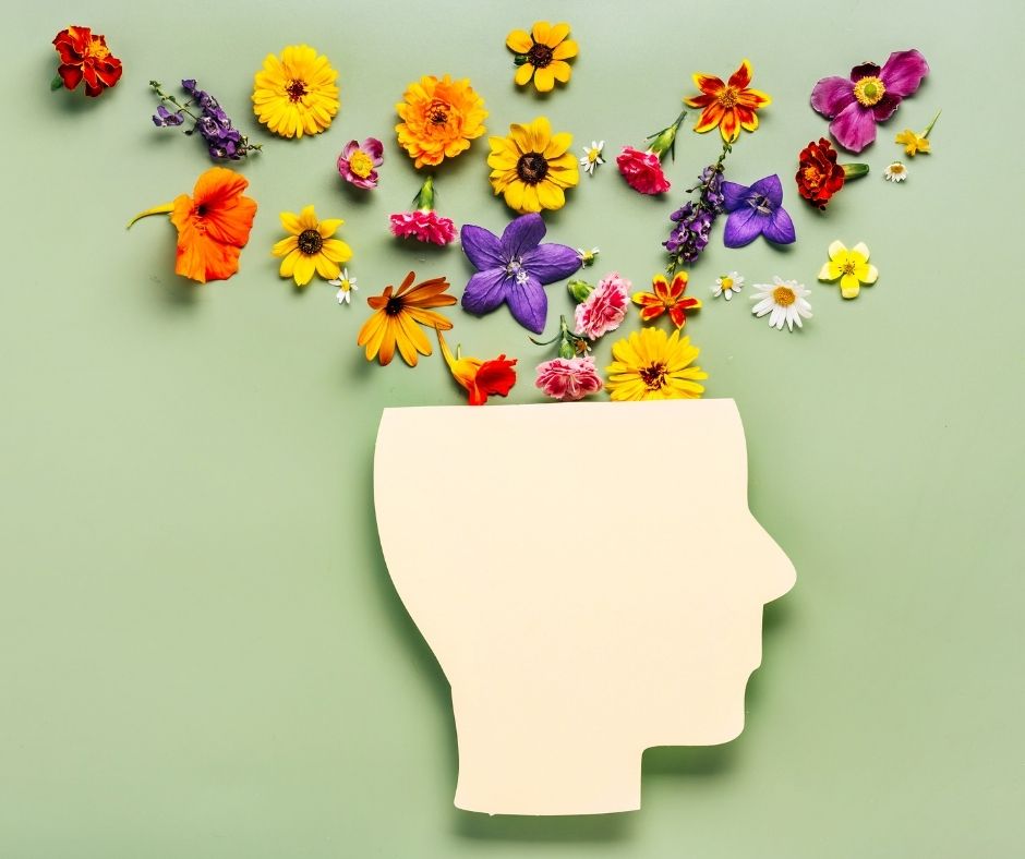Flowers pouring from within a calving shaped like a head 