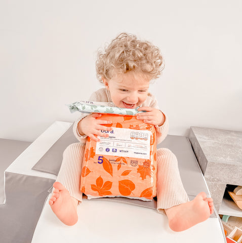 Small child with Pura nappies and wipes