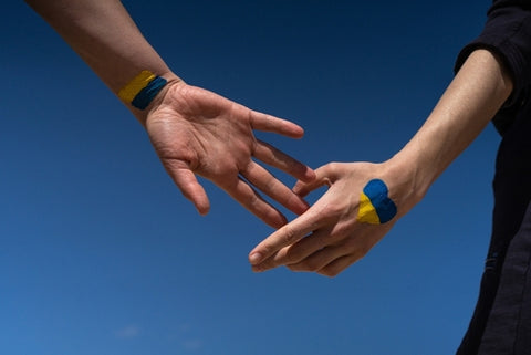 people holding hands - Ukrainian flag on arms 